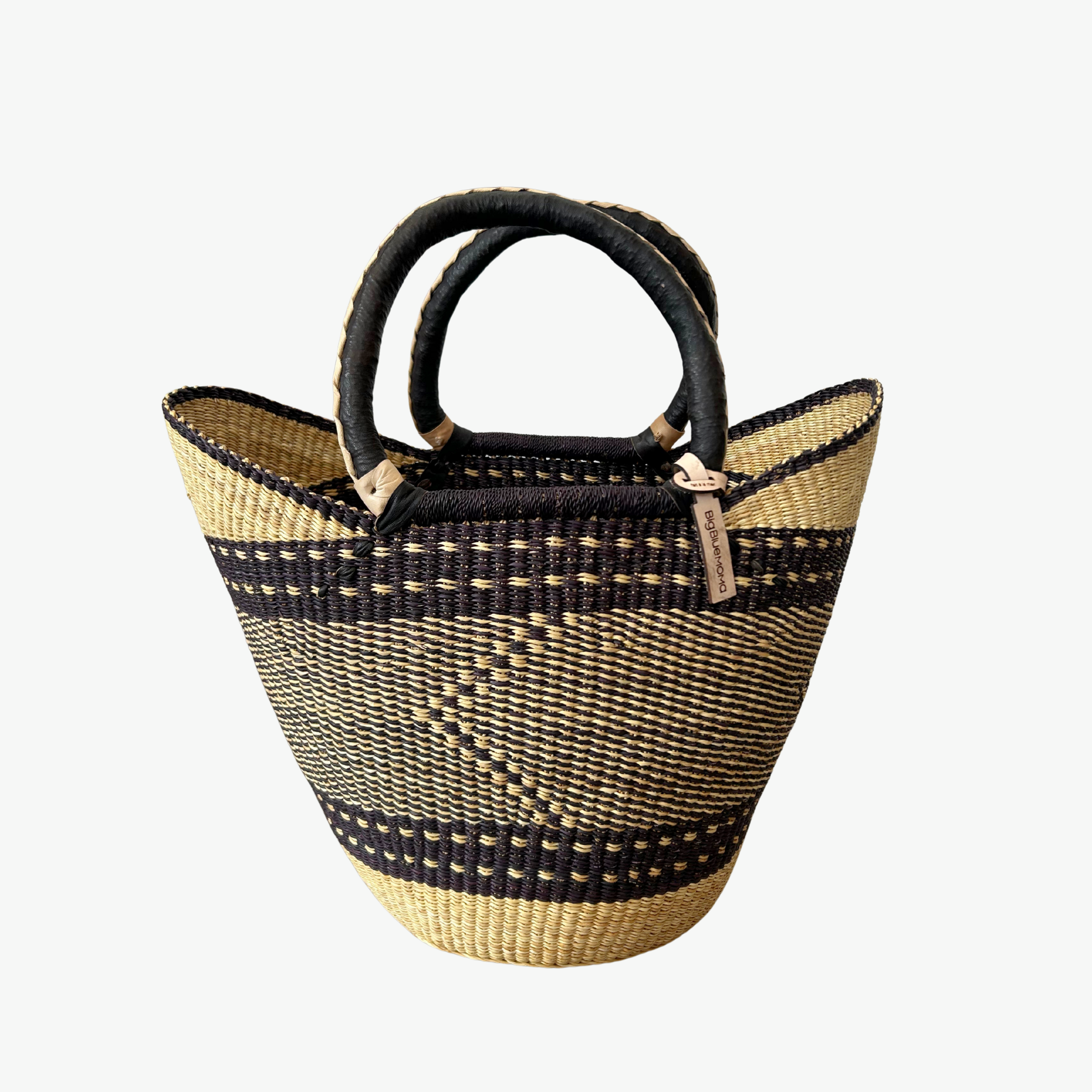 Woven basket with black and natural pattern on a white background
